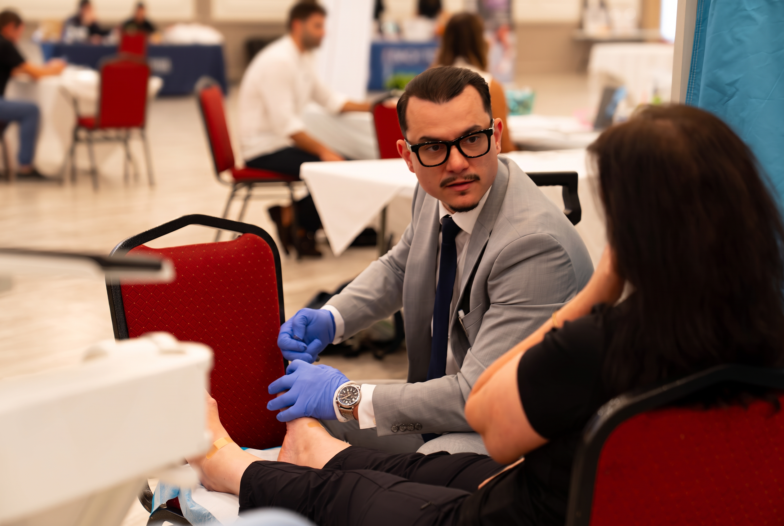 A provider examining a community member's foot and ankle